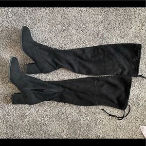 Over the knee black boots.